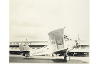 US Navy Biplane in Front of Fort Worth Airport, Meacham Field Hangar, photograph, undated