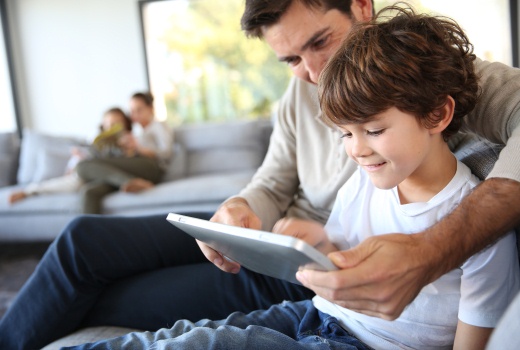 Dad and son looking at a tablet