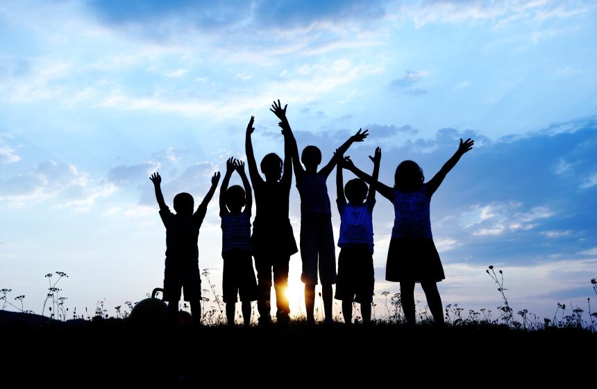 Children with hands up in the air