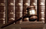 gavel on pedestal with law books in background