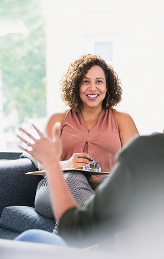 Professional woman taking notes from client