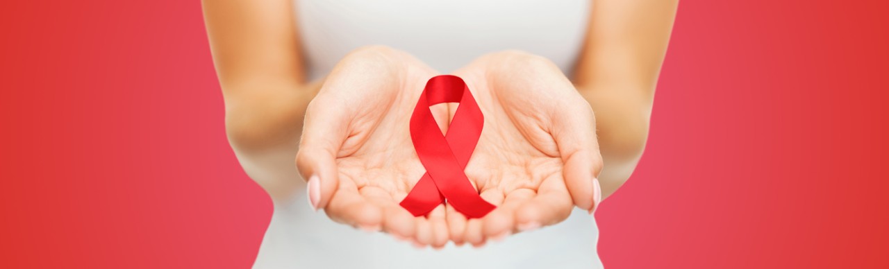 woman holding red ribbon in cupped hands