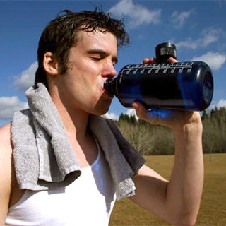 man drinking water after workout