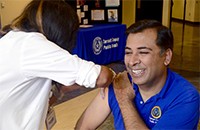 TCPH Director Vinny Taneja getting flu shot